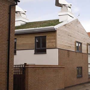 View Zero Carbon Terraced Housing - Cedar cladding and sedum roof